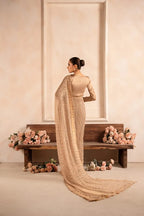 Champagne pre-draped saree gown styled for festive occasion