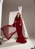 Woman wearing red mermaid evening gown with sheer flowy sleeves