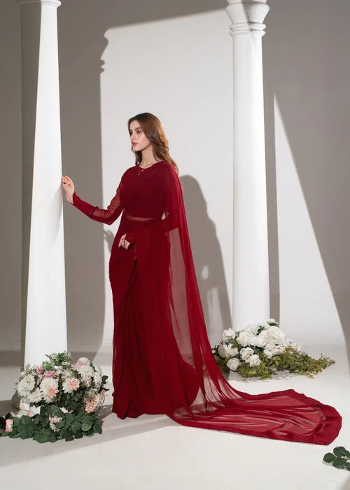 Woman wearing red mermaid evening gown with sheer flowy sleeves
